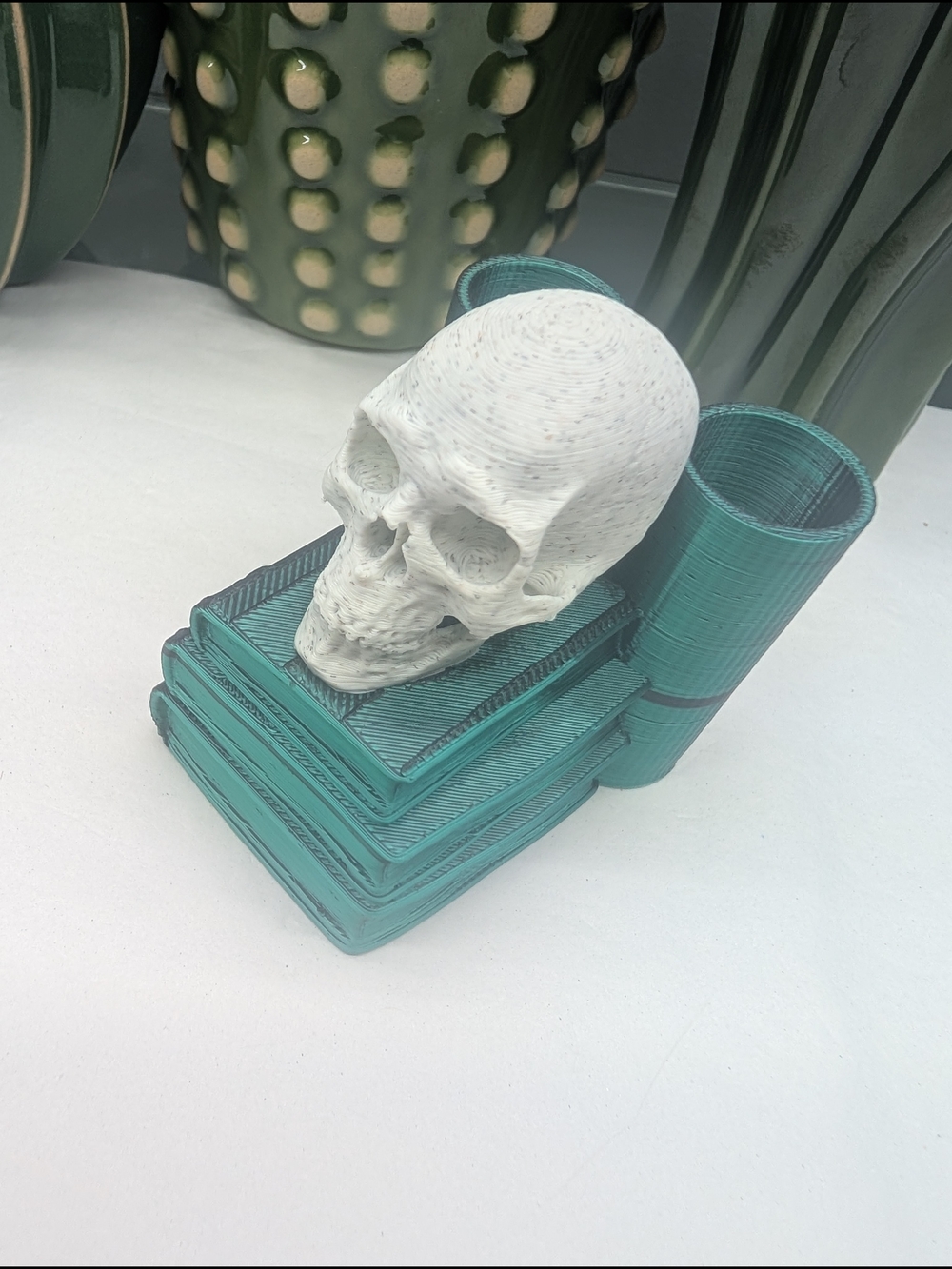 3D Printed Pen Holder W/White Skull on Teal Decorative Book Stack